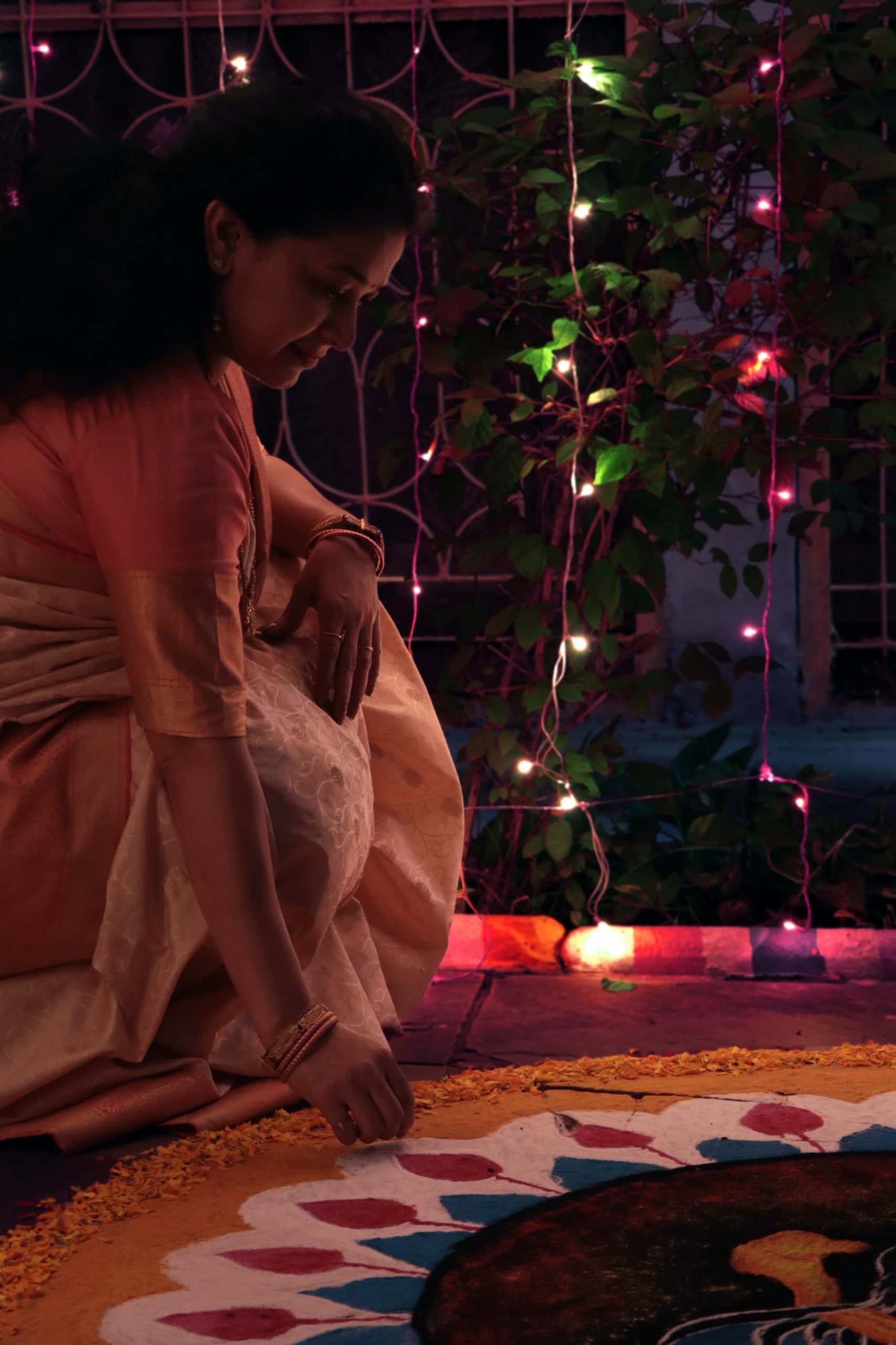 Free Photo | Scene photo of Indian woman kneeling by candles celebrating  Diwali